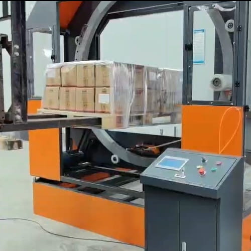 Horizontal pallet wrapping machine for Metal fabricators — forklift-operated wrapping cycle